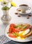Breakfast with egg poached, toasted, bacon, tomatoes and coffee
