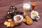 Breakfast with espresso, latte and cappuccino, crackers, holder with ground coffee, tamper and cans of coffee beans on wooden