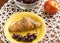 Breakfast food croissant and cherries in a yellow plate, ripe peach, cherries in a glass bowl