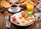 Breakfast with fried eggs, coffee, juice and fresh fruits