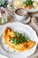 Breakfast. Frittata - italian omelet. Omelette with tomatoes, arugula and soft cheese. Coffee and other dishes on the
