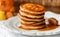 Breakfast. Fritters with honey on a white plate. Homemade pancakes