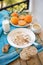 Breakfast, fruit, corn flakes, milk and orange juice on the wooden table