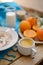 Breakfast, fruit, corn flakes, milk and orange juice on the wooden table