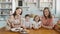 Breakfast for an happy family, sisters twins moms with two childs girl and boy morning eating sweets desserts and fruits