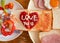 Breakfast have fried egg ham bread and salad. On the bread have heart drawing and text love you is made by ketchup and mayo.