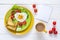 Breakfast with heart-shaped fried egg, toast, cherry tomato, let