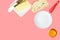 Breakfast ingredients butter slice of bread cracked raw egg frying pan on pink background. Culinary food poster