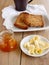 Breakfast with integral toast, butter and apricot jam on wooden table