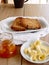 Breakfast with integral toast, butter and apricot jam on wooden table