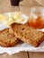 Breakfast with integral toast, butter and apricot jam on wooden table