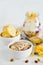 Breakfast in a jar: cornflakes, banana, fresh berries, granola, yogurt on a light background. The concept of healthy eating, high-