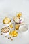 Breakfast in a jar: cornflakes, banana, fresh berries, granola, yogurt on a light background. The concept of healthy eating, high-