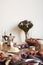 Breakfast in modern kitchen with croissants, figs, coffee, bread on board over rustic wooden table