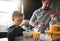 Breakfast is the most important meal of the day. a young boy and his father having breakfast in the kitchen.