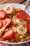 Breakfast muesli with strawberries and banana closeup vertical