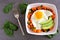 Breakfast nutrient bowl with sweet potato, egg, avocado and spinach on slate