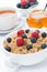 Breakfast - oat porridge with fresh berries and honey, black tea