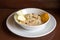Breakfast Oatmeal with apple, raisins, orange on wooden background_