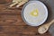 Breakfast: oatmeal with butter, top view. Flakes in a wooden spoon.