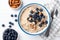Breakfast oatmeal porridge bowl with almonds and blueberries