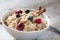 Breakfast oatmeal porridge with cinnamon, cranberries and blueberries