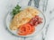 Breakfast omelet of eggs on a white marble background.