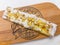 Breakfast open sandwich with ricotta cheese, honey, nuts on a rustic wooden board