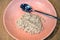 Breakfast. Organic oatmeal porridge on pink plate