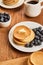 Breakfast with pancakes, butter, blueberries and