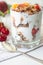Breakfast parfait with yogurt, granola, peach and sour cherries in a glass.