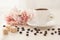 Breakfast in pastel colors. Cup of coffee standing on the table with coffee beans scattered around and pieces of  cane sugar ,