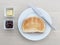 Breakfast plate toast knife butter jam jelly on wood table