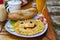 Breakfast with scrambled eggs, cheerful breakfast, omelette with a smile from ketchup, bread, vegetables  salad