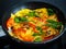 Breakfast - scrambled eggs with vegetables in frying pan