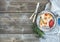 Breakfast set. Thin crepes with red caviar on rustic metal plate, fresh thyme and vintage dinnerware over a rough wood