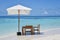 Breakfast setup at the beach in the ocean at the luxury resort at the tropical island with table, chairs, umbrella