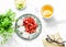 Breakfast or snack table - fresh strawberries, meringue, green tea with lemon. Cozy home still life on a light background