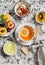 Breakfast or snack table. Lemon tea, fresh fruit, yogurt with granola, biscuits