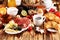 Breakfast on table with bread buns, croissants, coffe and juice