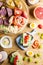 Breakfast table with cheese sandwiches, sausage, vegetables, hard boiled eggs and fruits