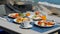 Breakfast table full of food at seaside restaurant, with sea view