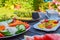 Breakfast table in the garden with various vegetarian and vegan snacks