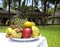 Breakfast on the table of healthy exotic fruits on vacation in tropical Vietnam on the street on the background of houses and palm
