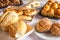 Breakfast table in hotel, with sweets, cakes, cheese bread and bread. Brazilian Mineira food and cuisine