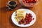 Breakfast on the table, pancakes , coffee and a bowl of berries