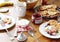 Breakfast table: pancakes, fruit salad, tea, yogurt