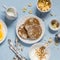 Breakfast table. Whole wheat pancakes, greek yogurt with homemade granola, orange slices, nuts, corn flakes