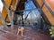 Breakfast on the terrace of a cabin in the woods on a wooden table with coffee and sweet bread ready to start the day