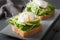 Breakfast toast with avocado, poached egg and alfalfa sprouts